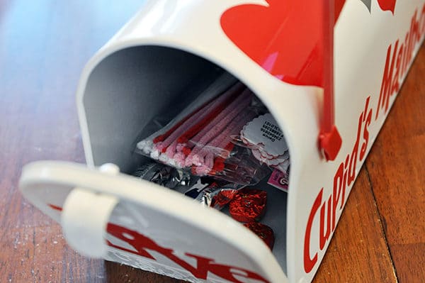 A white mailbox full of Valentine's Day goodies.