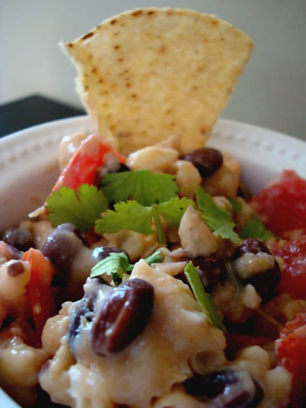 Bowl of black bean dip with chip.