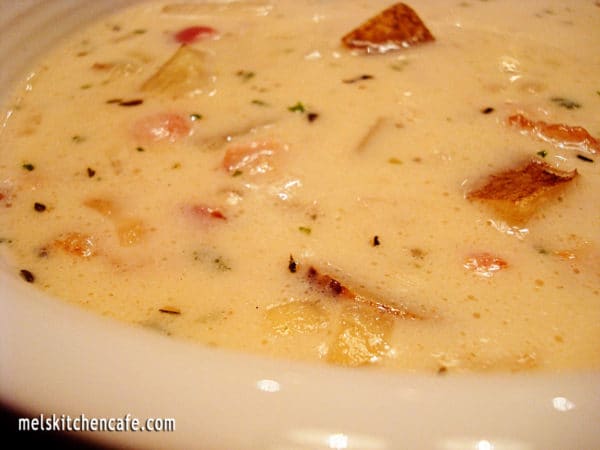 White bowl full of clam chowder.