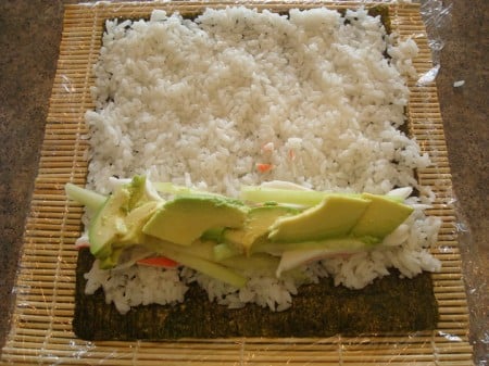 Crab Avocado Layered On Rice white rice, avocado, and crab meat on a sheet of nori