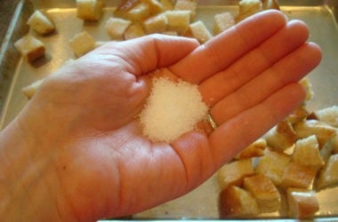 Coarse salt handful of coarse salt over a pan of bread cubes