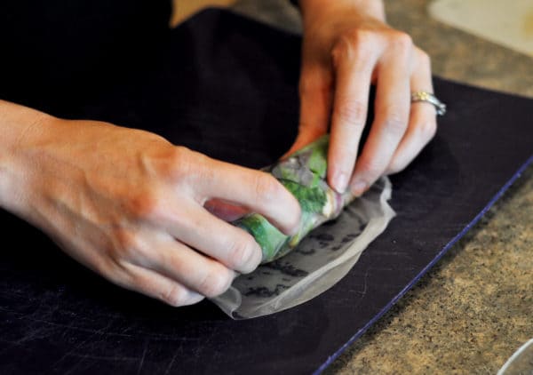 Rolling the last part of a rice wrap up with vegetables in it