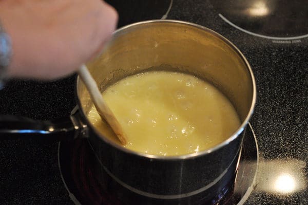 melted butter bubbling in a saucepan with a wooden spoon stirring it