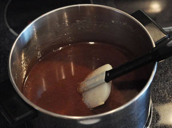 chocolate caramel liquid mixture in a large stainless steel pot
