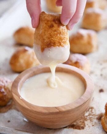 dipping easy homemade soft pretzel bites in homemade cheese sauce