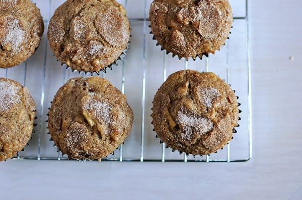 Top view of cinnamon coated apple muffins on a cooling rack.