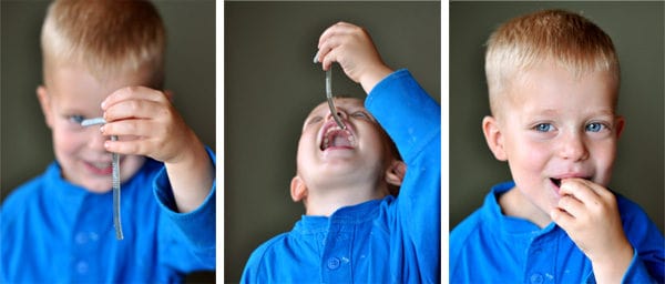 A little boy with 3 side-by-side shots eating a Jello worm.