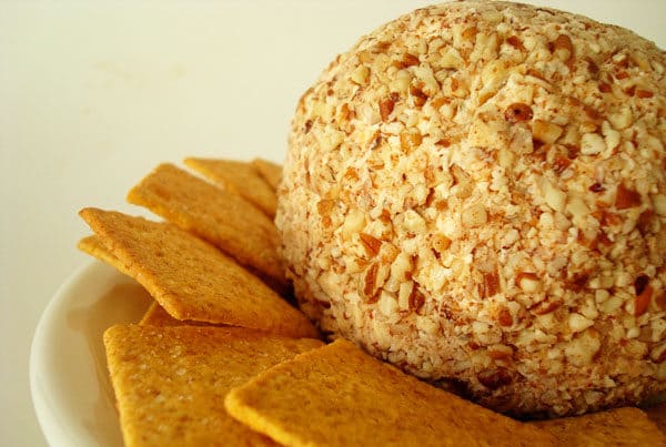 cheeseball and crackers on a white plate