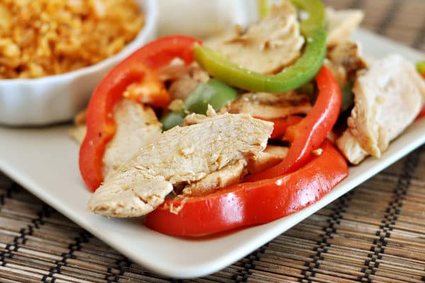 White plate of fajita chicken and peppers.