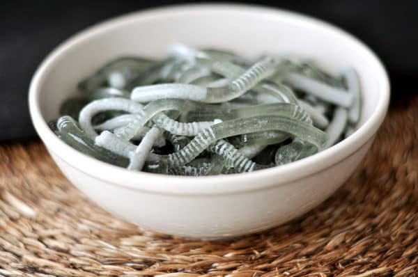 A white bowl full of Jello worms.