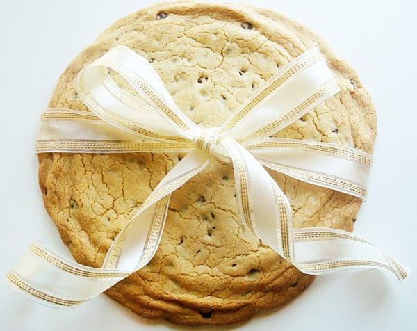 a giant chocolate chip cookie wrapped with a bow
