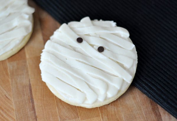 Sugar cookie with strips of frosting to look like a mummy.
