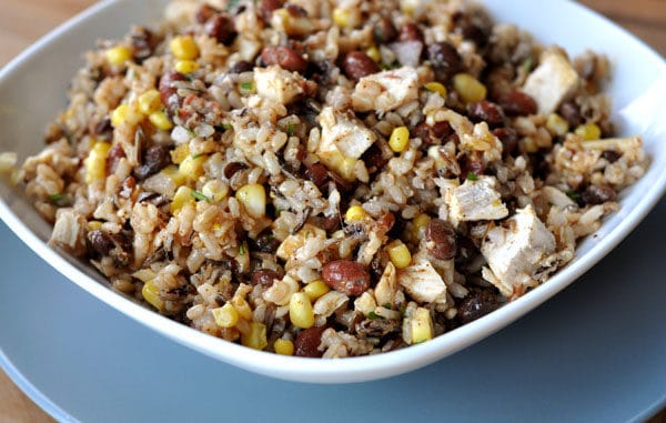 Southwest rice, bean, corn, and chicken salad in a white bowl.