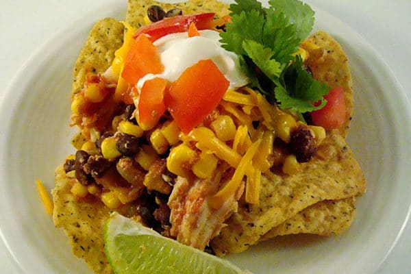Chicken, corn, and black beans over chips.