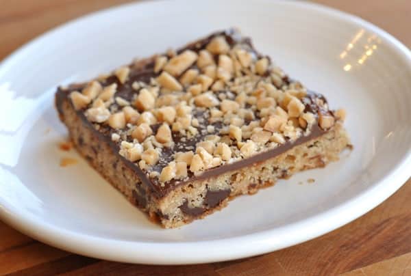Chocolate toffee shortbread bar on a white plate.