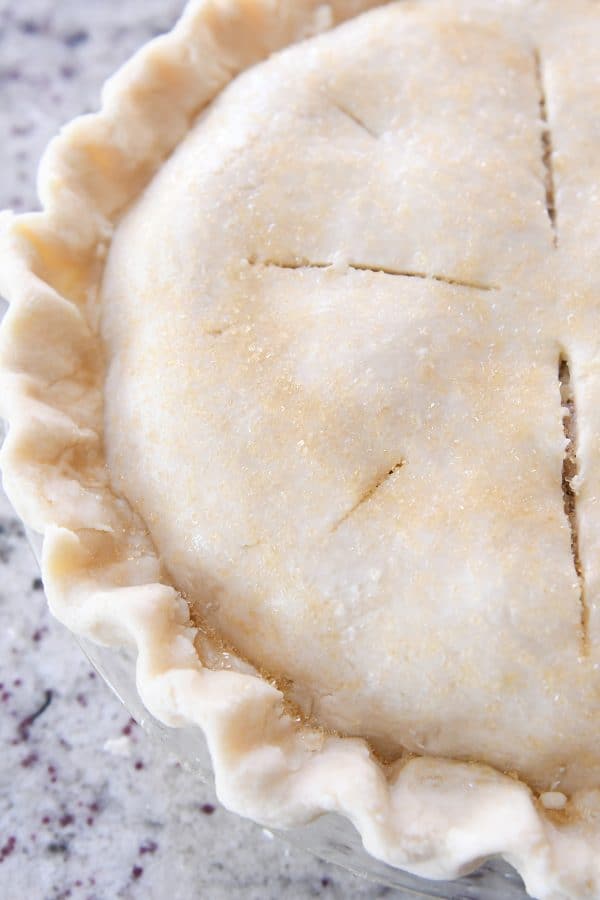 Fluted pie crust with slits on top.