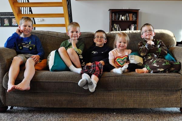 five little kids sitting on a couch together