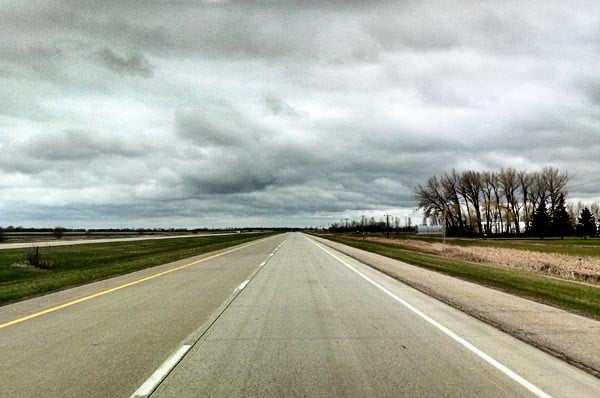 A wide open road with no cars on it.
