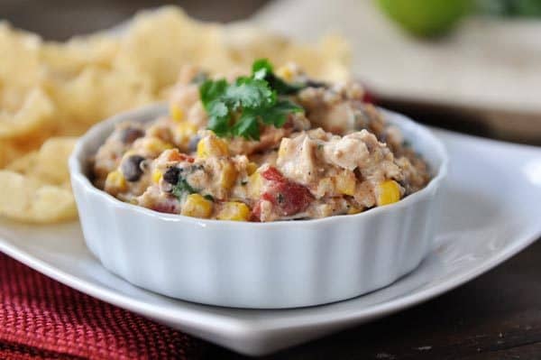 A white ramekin full of a creamy corn and quinoa tex-mex mixture.