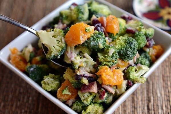 A white square dish full of mandarin broccoli salad. 
