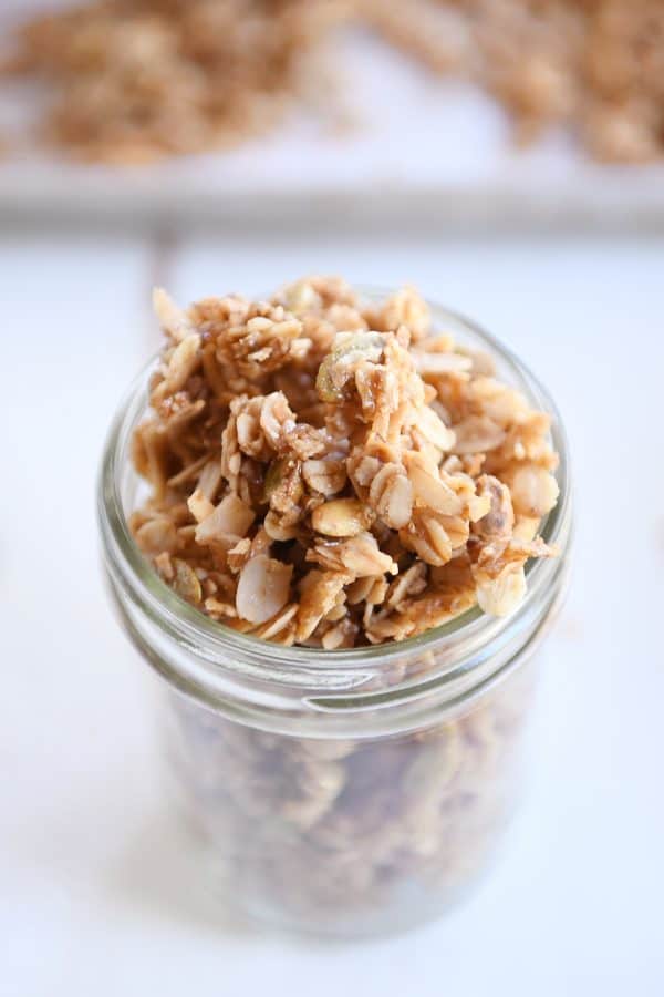 Glass jar filled with brown butter pecan granola.