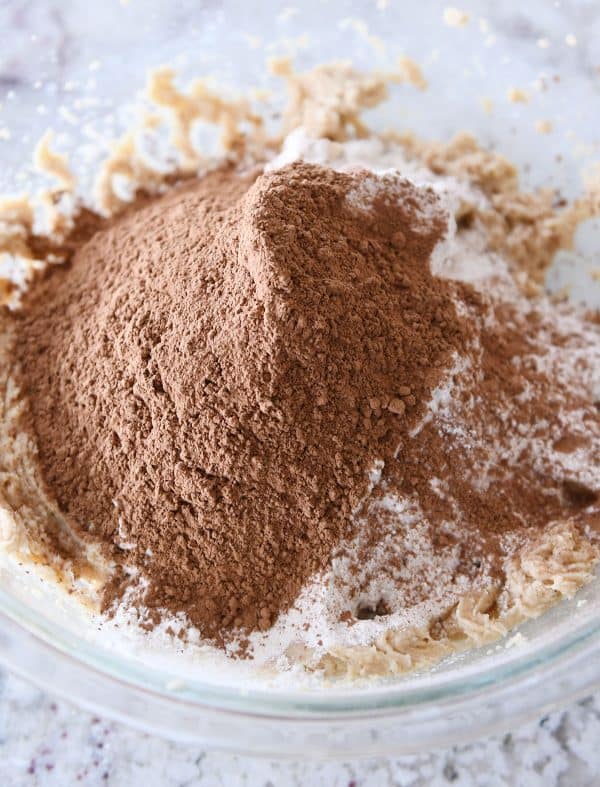 Dry ingredients in glass bowl for chocolate peanut butter buckeye cookies.
