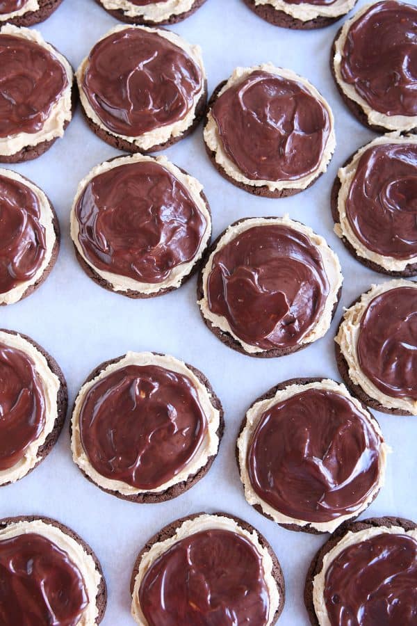 Top down view of a lot of chocolate peanut butter buckeye cookies on baking sheet.