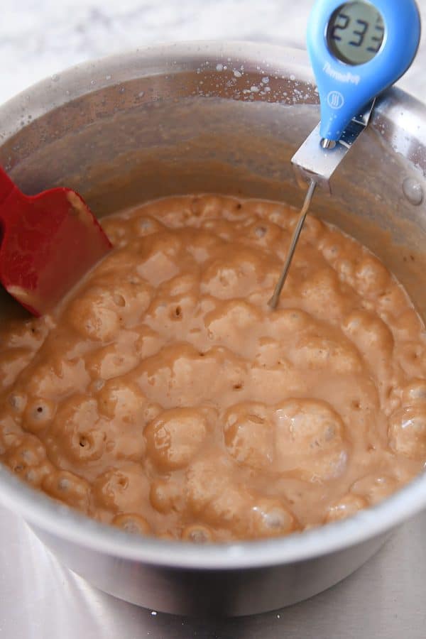 Cooking caramels to 245 degrees in a metal pot.