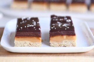 Two homemade grown up Twix bars on white tray.
