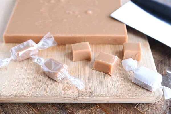 Cutting and wrapping homemade caramels.