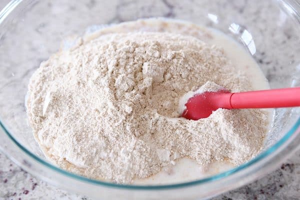Stirring in dry ingredients to english muffin batter.