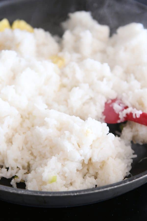 Adding rice to skillet for easy ham fried rice.