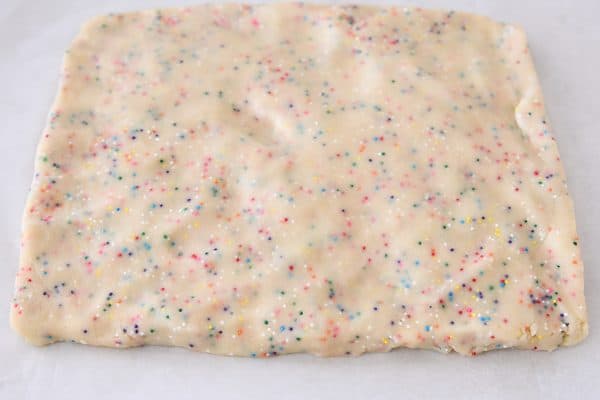 Pressing dough into rectangle for funfetti shortbread bites.