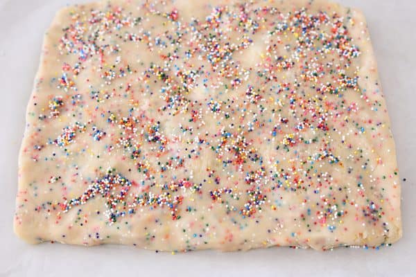 Pressing dough into rectangle for funfetti shortbread bites.