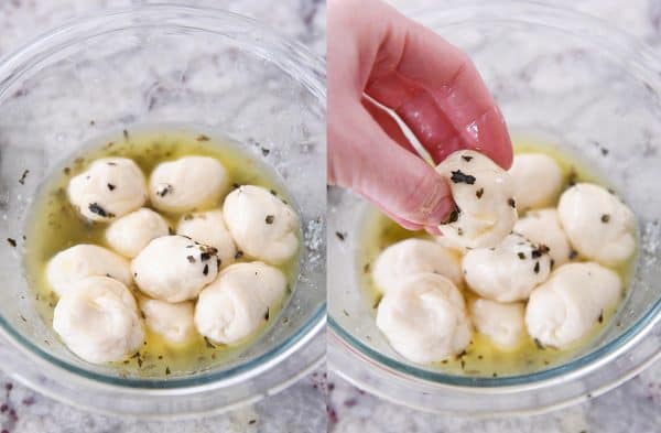 Dipping pieces of pull-apart bubble bread in butter seasonings mixture.