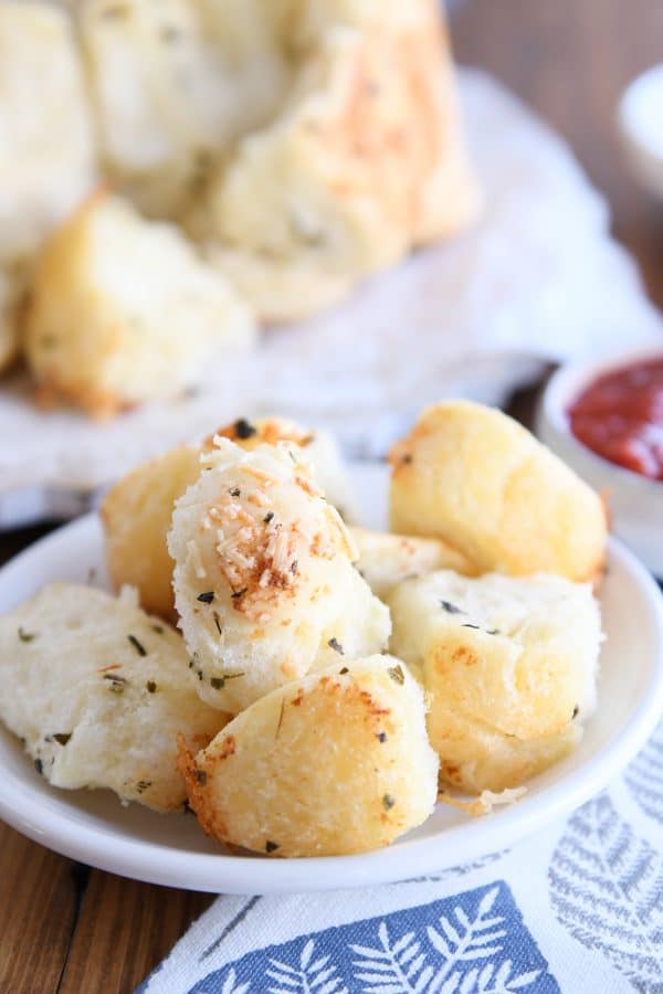 Pieces of pull-apart bubble bread on white plate.