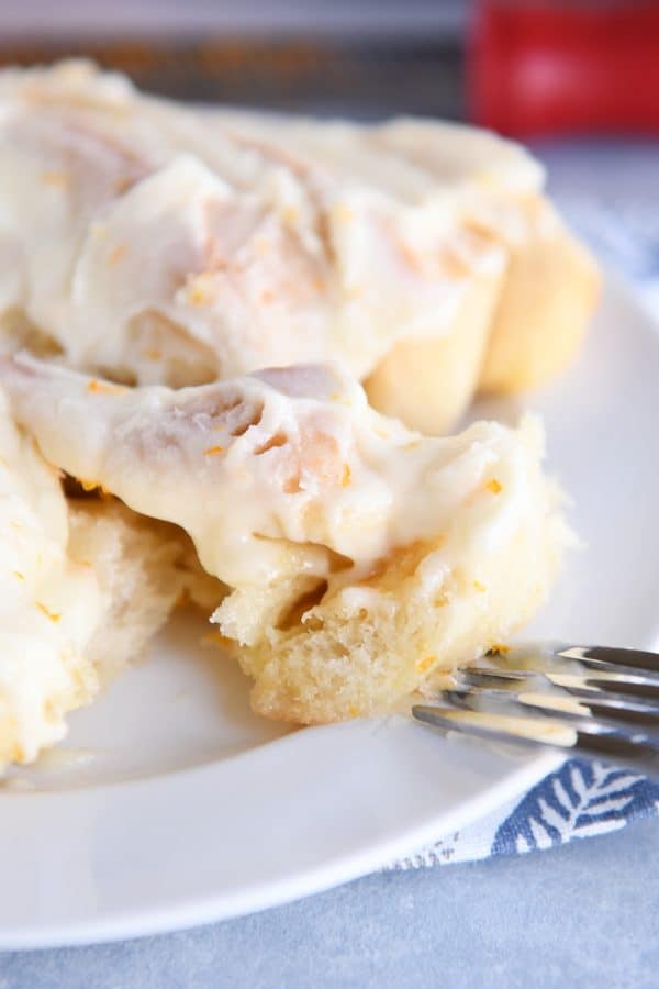 Taking bite out of homemade orange sweet roll.