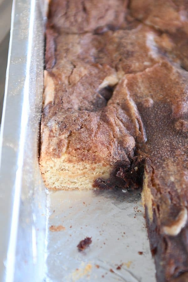 Piece cut out of pan of snickerdoodle brookie bars.