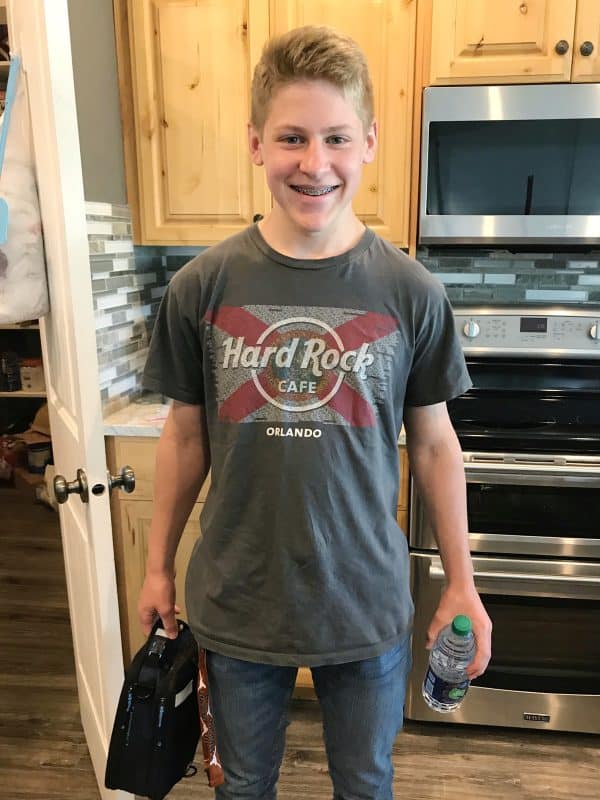 teenager with lunch and water bottle