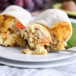 easy freezer breakfast burrito cut in half with bite on fork on white plate
