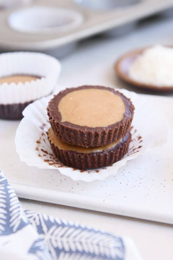 Two unwrapped no-bake peanut butter cups stacked on top of each other.