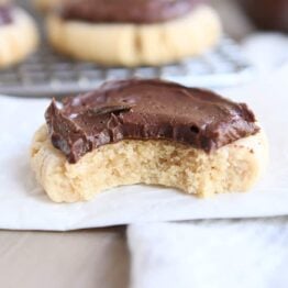 peanut butter sugar cookie with chocolate frosting on white napkin