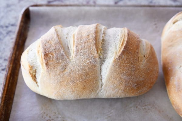 Loaf of sourdough bread on sheet pan.
