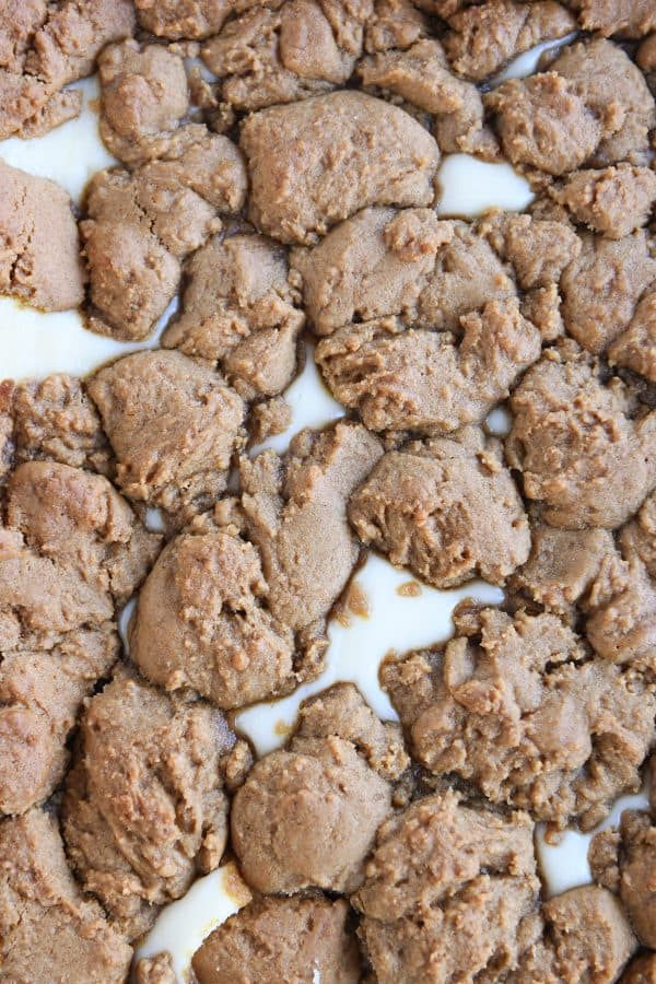 Top puffy layer of gingerbread dough on baked gingerbread cookie cheesecake bars.