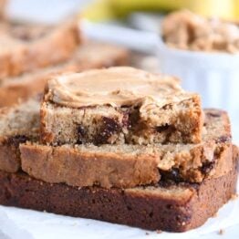 three peanut butter banana bread slices with peanut butter spread on top