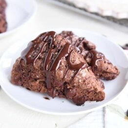 two triple chocolate scones on white plate