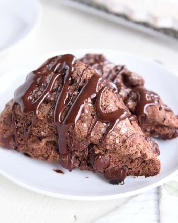 two triple chocolate scones on white plate