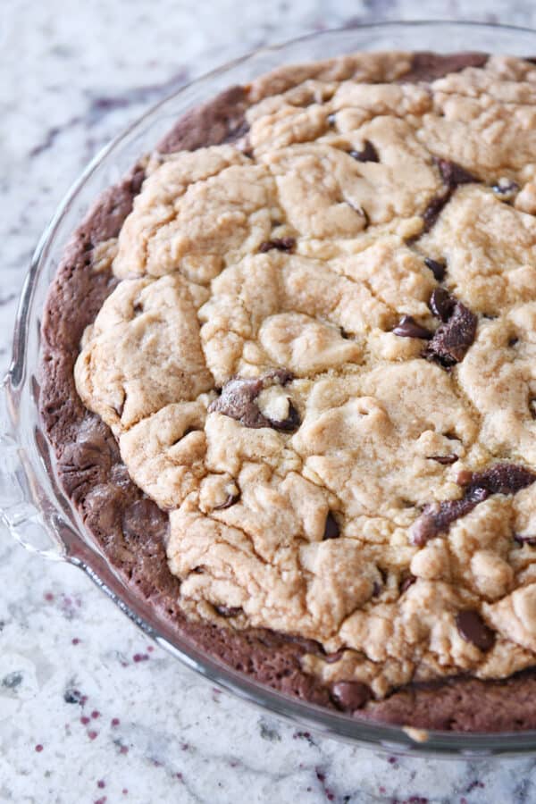 Baked brookie pie in glass pie plate.