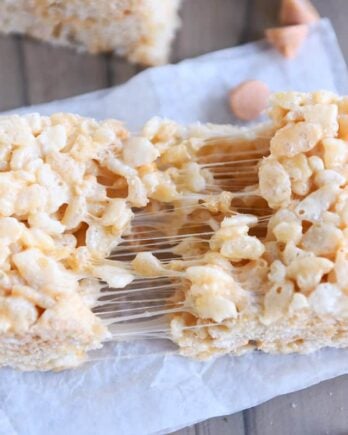 butterscotch rice krispie pulled in half on white parchment paper