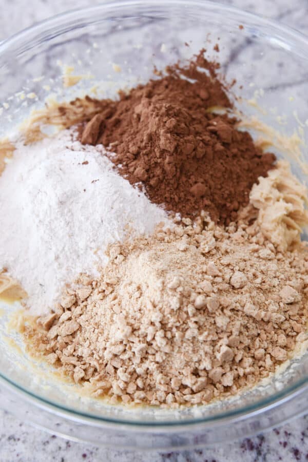 Flour, cocoa powder, and graham cracker crumbs in glass bowl.